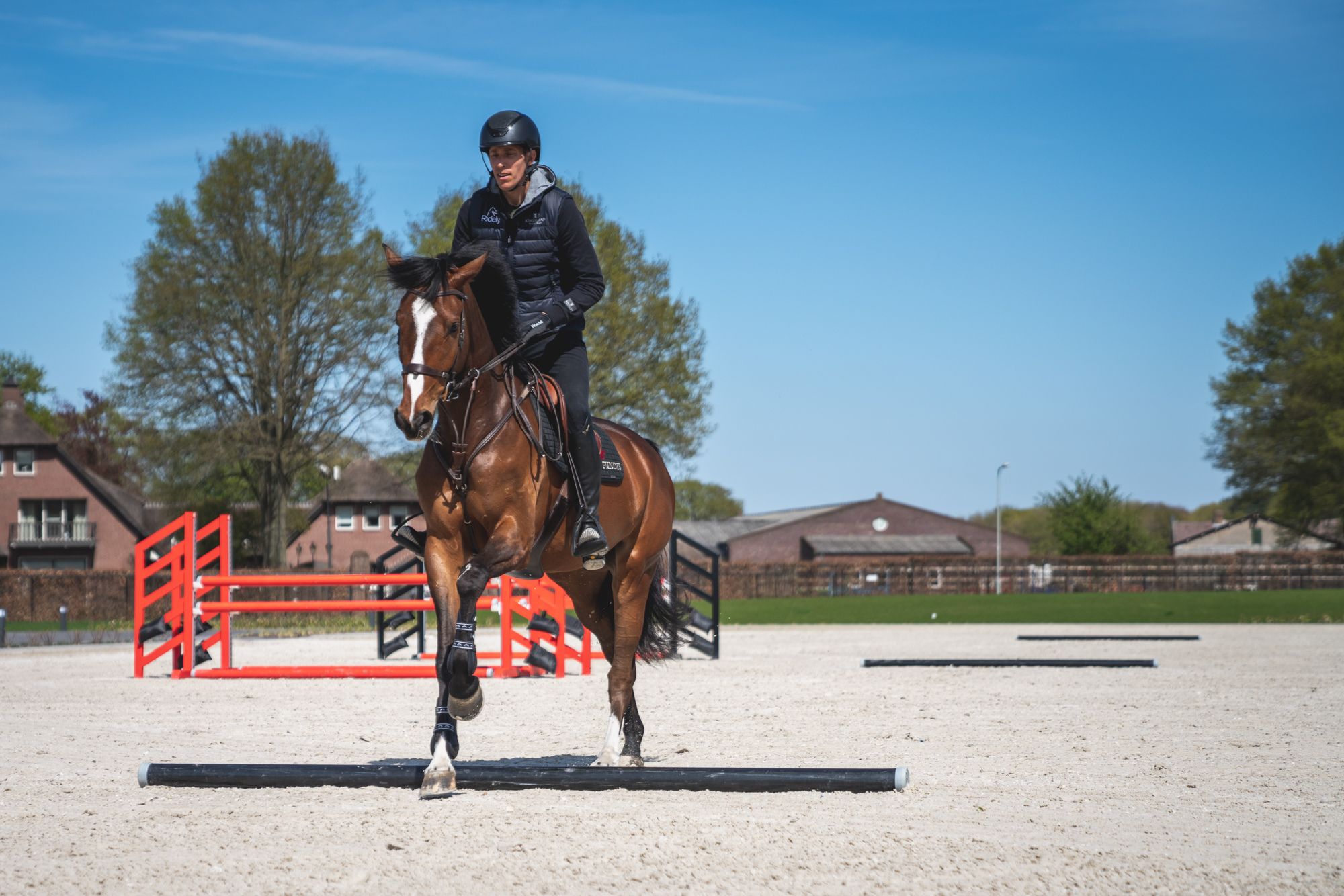 Henrik von Eckermann riding over 3 poles while training his horse