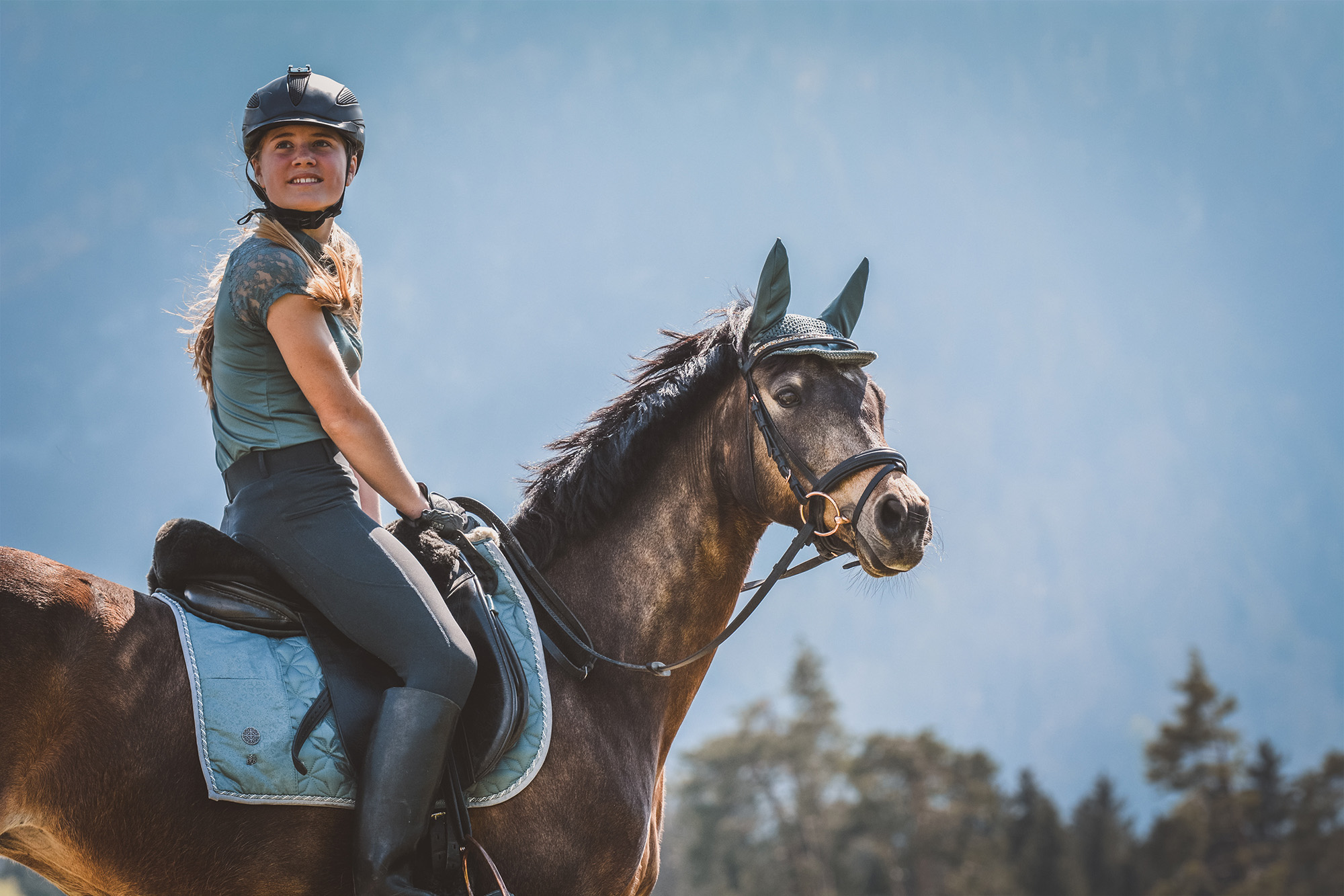 Profile image of Meredith Michaels Beerbaum holding a tacked up young horse.